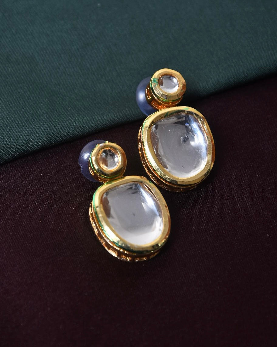 A pair of gold and crystal stud earrings with a round and teardrop-shaped design.