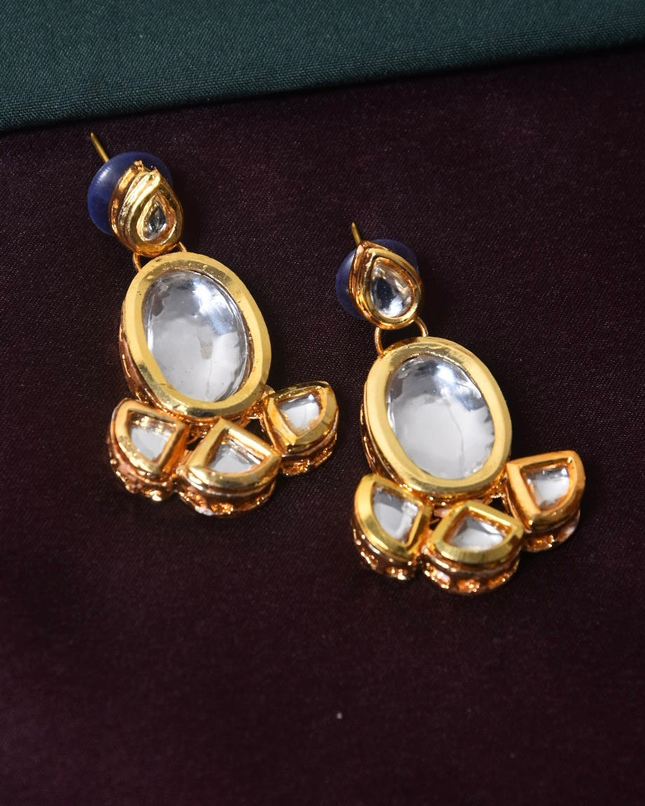 Gold and crystal drop earrings with blue and white accents.