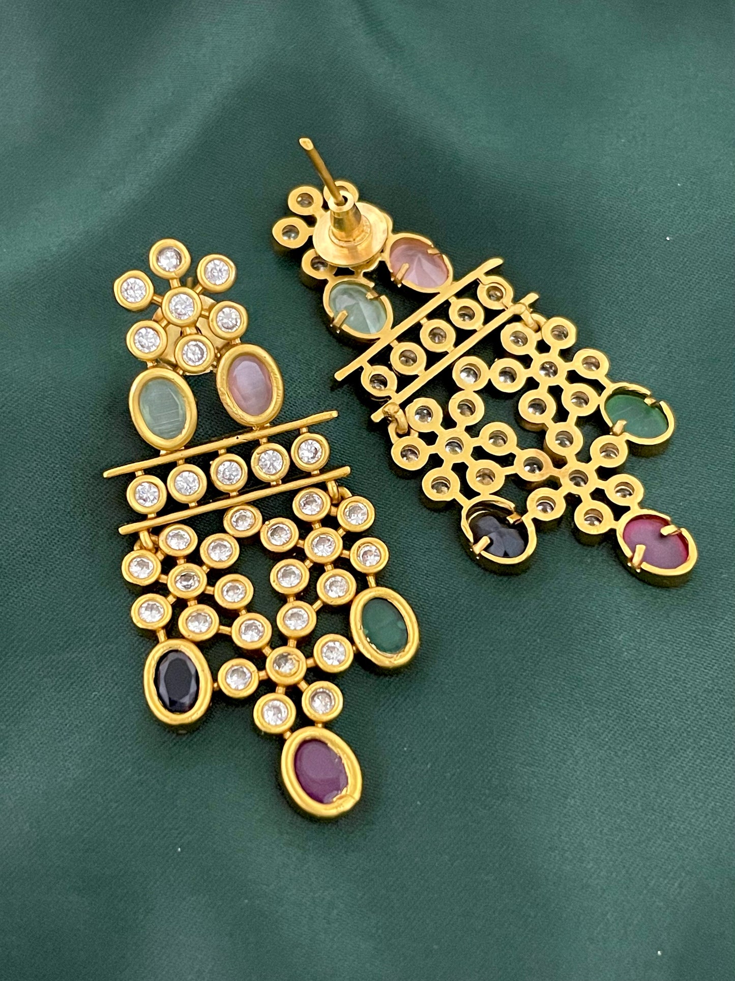 A pair of gold earrings with multiple gemstones and small diamonds.