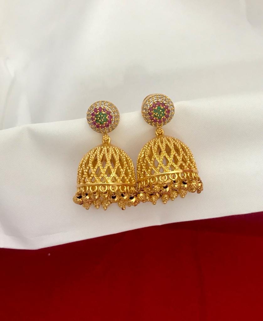 Gold jhumka earrings with multi-color stones and a matte finish.