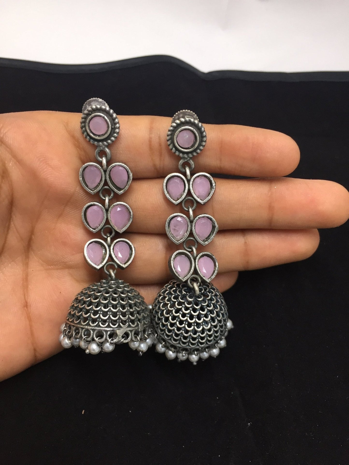 Blushing pink soft pink hanging jhumki earrings with intricate design and bead details.