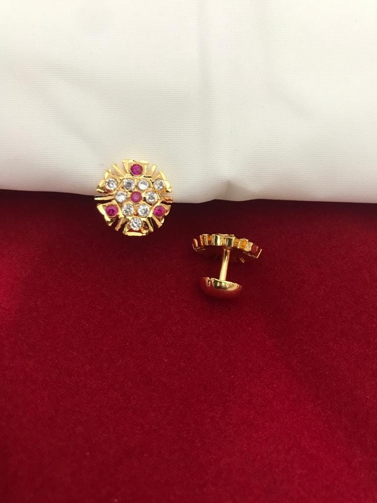 Gold metal studs adorned with American diamond stones and pink gemstones.