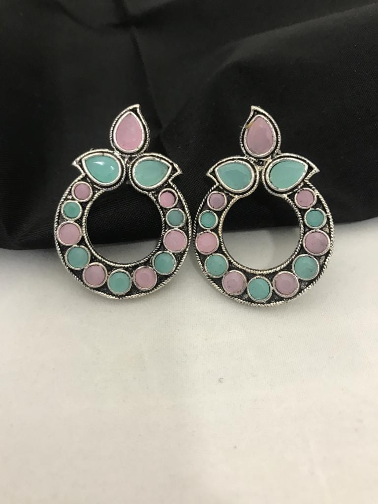 Light pink and mint oxidized earrings with circular design and leaf-shaped accents.