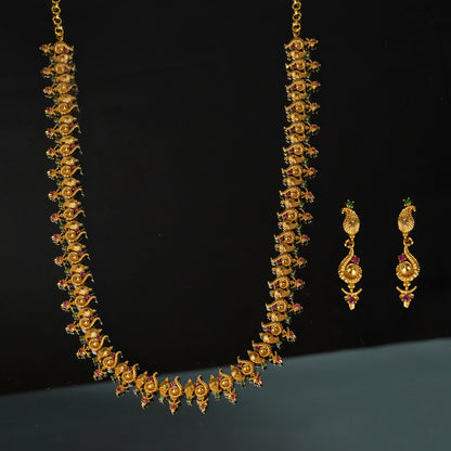 Gold necklace with intricate design and matching earrings.