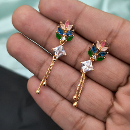 A pair of gold earrings featuring colorful gemstones and dangling chains.