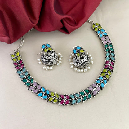 A colorful necklace and matching earrings set with intricate designs and pearl accents.
