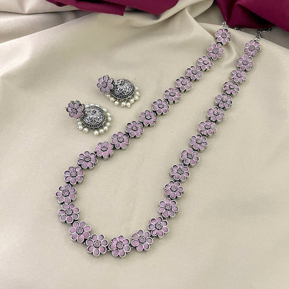 A necklace and a pair of earrings with pink flower designs.