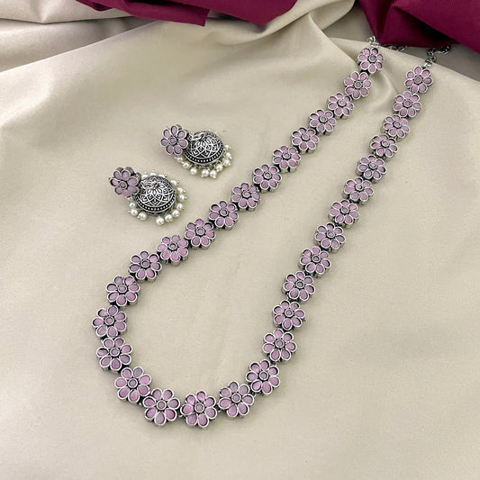 A necklace and a pair of earrings with pink flower designs.