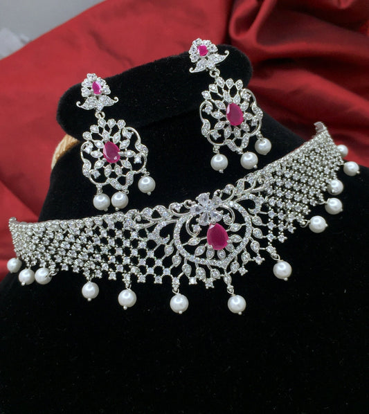 Silver-plated choker set with ruby stones and matching earrings, adorned with pearls.