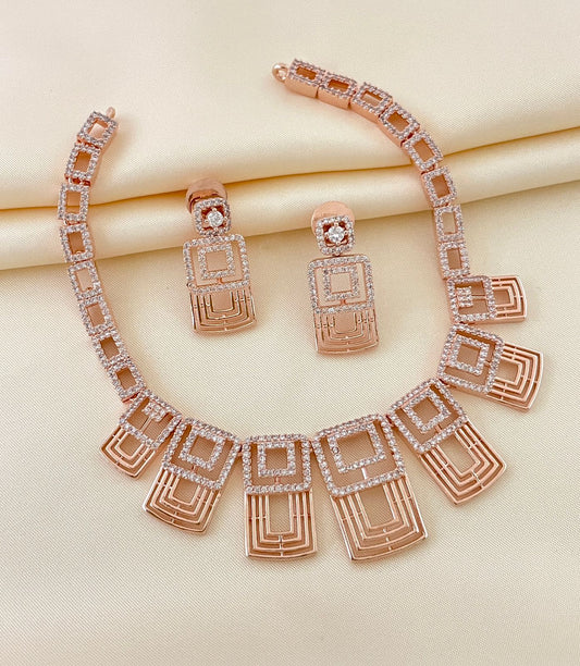 Rose gold geometric necklace with matching earrings adorned with American diamonds.