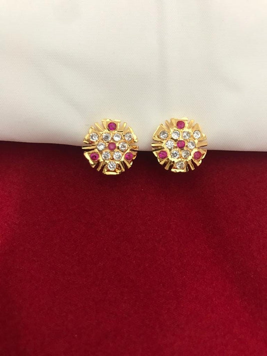 Gold round earrings with red and white stones.