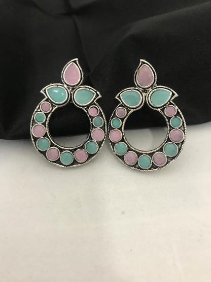 Light pink and mint oxidized earrings with circular design and leaf-shaped accents.