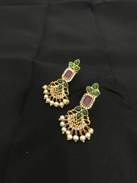 Gold earrings with green and red stones, adorned with pearl dangles.
